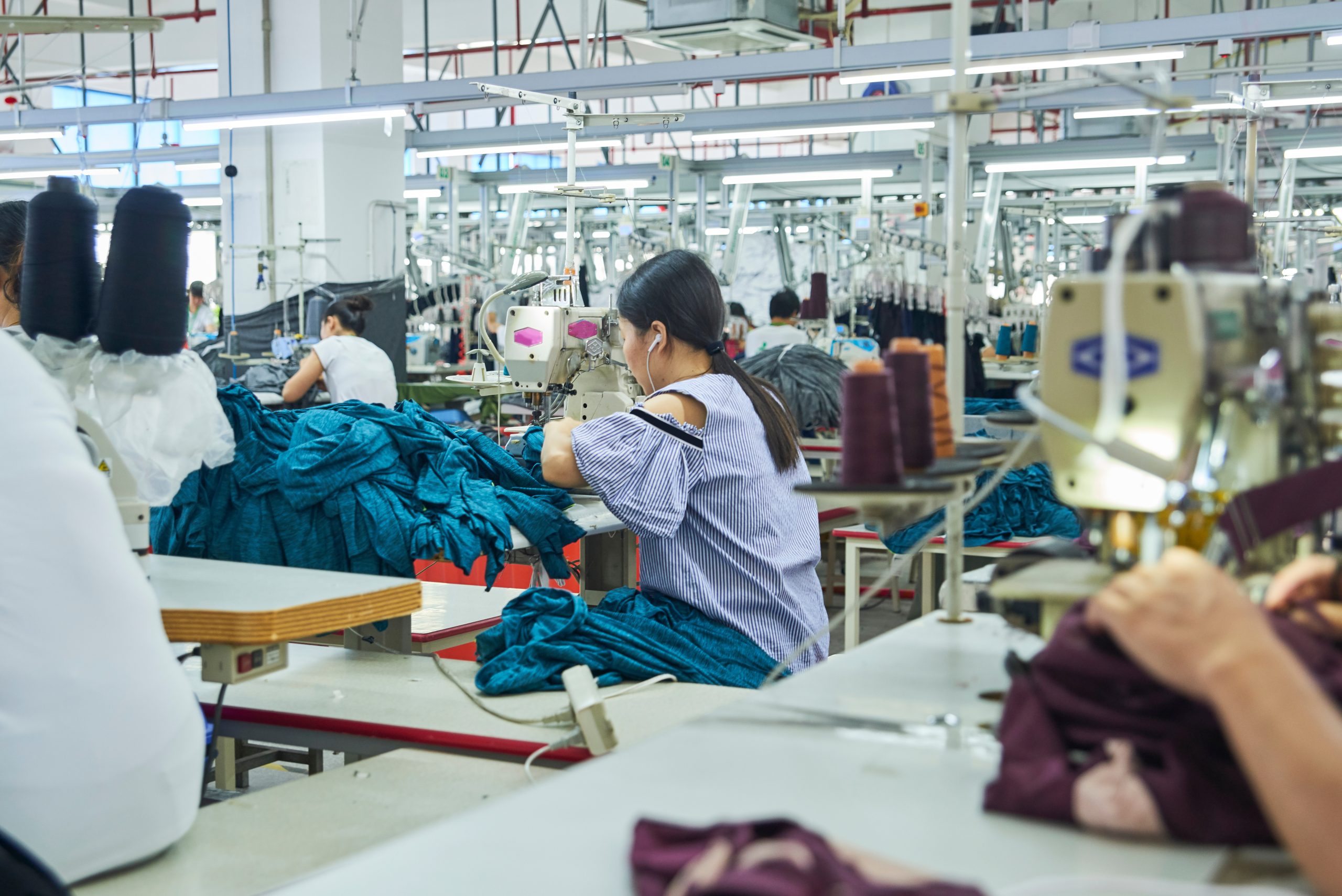 Employee’s working with their sewing machines in clothing factor Employee’s working with their sewing machines in clothing factor